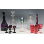 A collection of glassware to include, a cut glass decanter, a purple decanter together with four