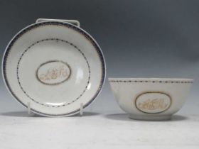 An 18th century Chinese export bowl and stand, the centres monogrammed with initials AJMFading to