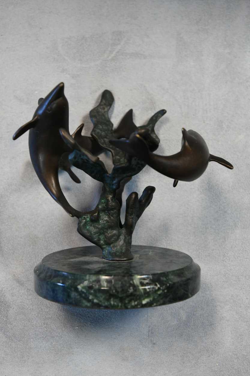 A bronze model of three swimming dolphins, the patinated model mounted to a green marble plinth - Image 5 of 8