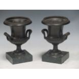 A pair of late 19th/ early 20th century bronze campana urns 15.5 cm high including bases (2)