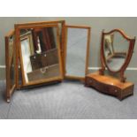 An Edwardian mahogany shield shaped dressing table mirror with a serpentine three drawer base, 59