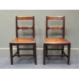 A pair of early 19th century fruit wood chairs with shaped cross rail back rest over a bow front