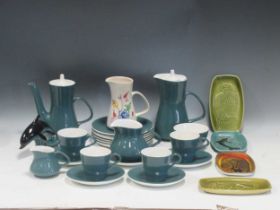 A collection of Poole Ware to include four cups, a milk jug, a coffee pot, a hot water pot,
