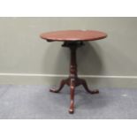 A George III style mahogany revolving top wine table on bird cage action and tripod base 73cm high