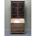 A George III and later mahogany bureau bookcase, the dental moulded cornice above two astragal