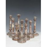 A set of 4 silver plated telescopic candlesticks, together with a further pair of silver plated