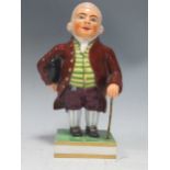 A Derby figure of a Regency gentleman, marks in orangeRubbing and wear to the glaze in some areas