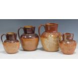 Four 19th century Doulton Lambeth salt glazed stoneware jugs with hunting relief decoration, largest