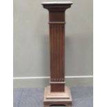 A 20th century oak pedestal, the square top over a fluted column 109 x 30 x 30cm