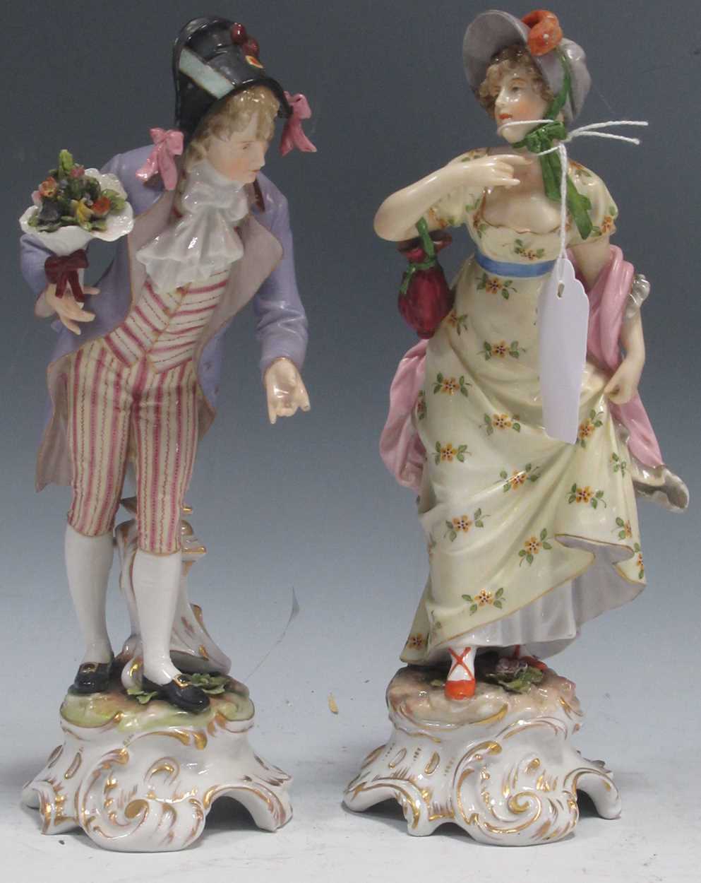 A pair of Dresden type porcelain figures of a gallant and his lady companion, probably Volkstedt,