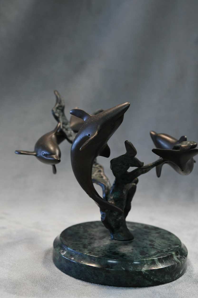 A bronze model of three swimming dolphins, the patinated model mounted to a green marble plinth - Image 8 of 8