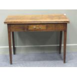 An oak fold over tea table with single frieze drawer on square tapered legs, 74 x 99 x 46cm (closed)