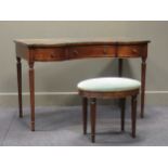 A mahogany dressing table of serpentine form with three drawers raised on fluted legs with