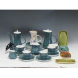 A collection of Poole Ware to include four cups, a milk jug, a coffee pot, a hot water pot,