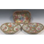 Three Canton porcelain platters, decorated with vases, birds, blossoms and temple scenes, 27.5 x