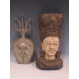 An Indonesian style carved and painted wooden head 25 cm high; together with another metal tribal