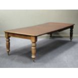 A late Victorian mahogany extending dining table with three additional leaves, the rounded