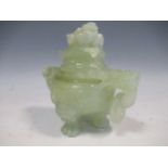 A Chinese jade censer and cover, carved with a pair of stylized dragon-head handles suspending loose