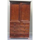 A 19th century mahogany linen press, the dental moulded cornice over panelled cupboard doors