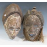 Two modern carved African masks, largest 38cm high (2)