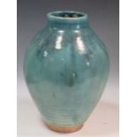 An impressive green glaze ovoid vase decorated in turquoise and shades of blue, the base incised