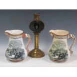 A pair of Alcock Royal patriotic 'Crimean War' jugs and a brass student lamp 21cm high (3)