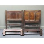 Two similar oak single bedsteads with panelled headboards, 3 foot wide