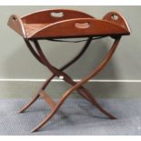 A mahogany butlers tray on folding stand 60 x 86 x 62cm and a reproduction canterbury 54 x 35 x 55cm