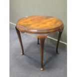 A walnut circular occasional table, with tapered legs on pad feet, 62cm high x 63cm diameter