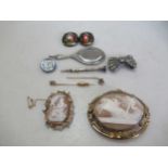Two shell cameo brooches together with two stick pins, one tested as 9ct gold, a collar pin and a
