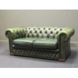 A modern button back Chesterfield type two seater sofa upholstered in green faux-leather, 67 x 160 x