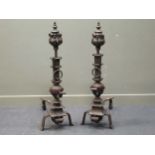 A pair of Country House Georgian style steel large andirons with foliate and scroll decoration on