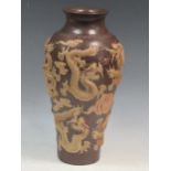 A Japanese earthenware vase with applied decoration of feilong and clouds, impressed mark to the