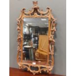 A George III style carved pine Rococo design wall mirror, with crescents, roses and acanthus
