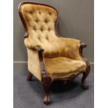 An early Victorian walnut framed spoon-back armchair with show-wood frame and foliate-carved