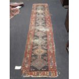 A Persian blue ground runner, 314 x 69cm; toegther with two together rugs (3)
