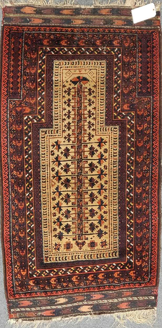 A late 19th century Beluchi prayer rug with sand coloured field148 x 86cmFringes and pile very