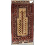 A late 19th century Beluchi prayer rug with sand coloured field148 x 86cmFringes and pile very