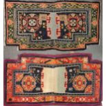 Two Tibetan saddle blankets, 133 x 72cmGreen surround: very worn especially to the fold down the