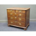 An 18th century walnut chest of two short over three long drawers raised on bun feet, 88 x 96 x