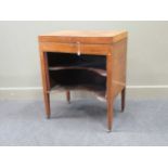 A George III mahogany veneered dressing table, with divided top above a recessed tambour cupboard,