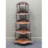 A Victorian walnut corner what-not with carved back, 150 x 71 x 37cm