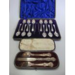 A cased set of 12 silver teaspoons with sugar tongs, together with a cased half set of fruit