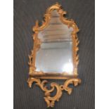 A Chippendale rococo style gilt wood wall mirror with shelf 117 x 52cm