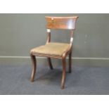 An early 19th century Biedermeier style mahogany dining chair with front sabre legs (damaged)