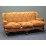 A George II style three-seater sofa with feather filled cushions and piped edge removable covers