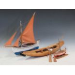 A painted wood model of a Greek sailing boat, the stand inscribed ‘A BepΩNHE MYKONOE’, 49cm long;