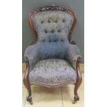 A Victorian mahogany button back armchair with pierced top rail on cabriole legs