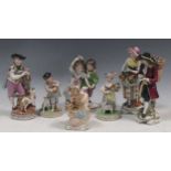 A Meissen figure of cupid with bird cage, a pair of Dresden figures, a Samson figure of a young