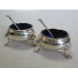 Two 18th century silver cauldron salts with blue glass liners and later spoons, 5.8ozt gross
